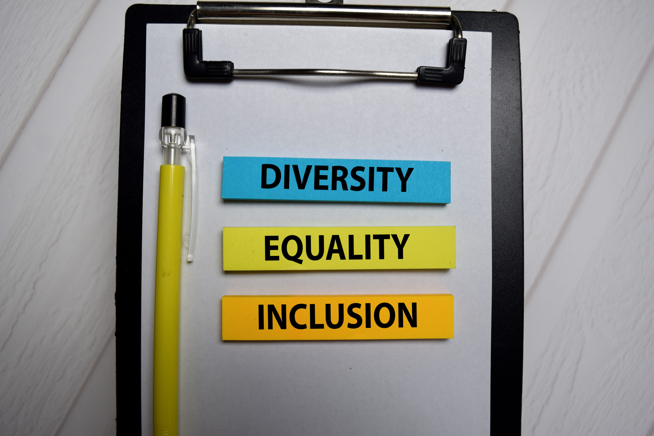 Diversity Equality Inclusion write on a sticky note isolated on