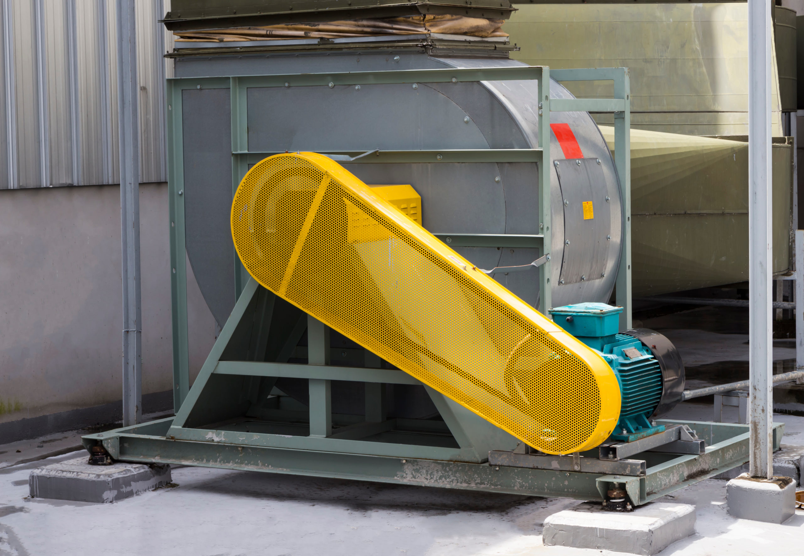 Yellow belt guard safety protection of motor ; prevent part of body touch into ; air duct blower machine ; industry equipment background