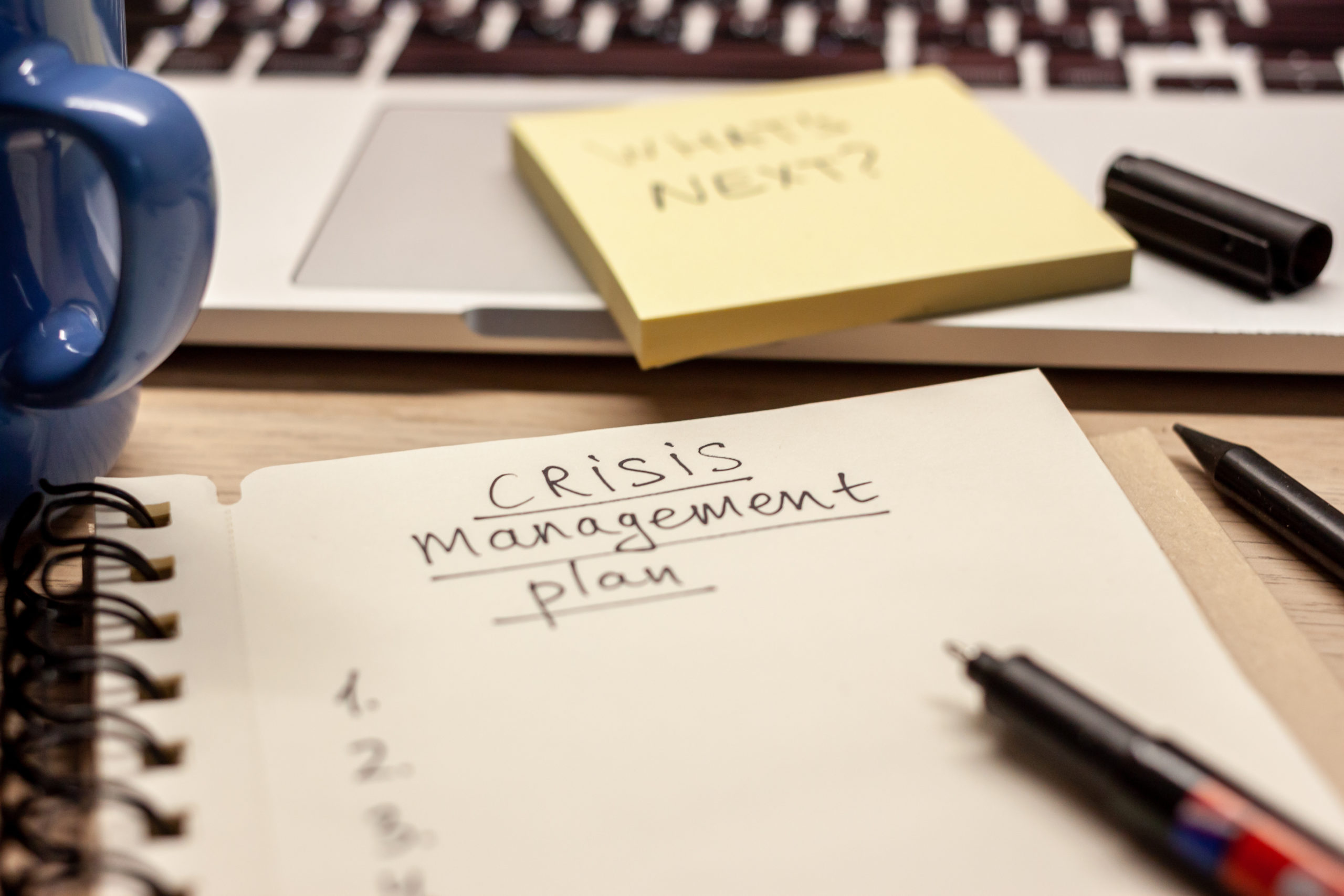 crisis management plan written words in notebook